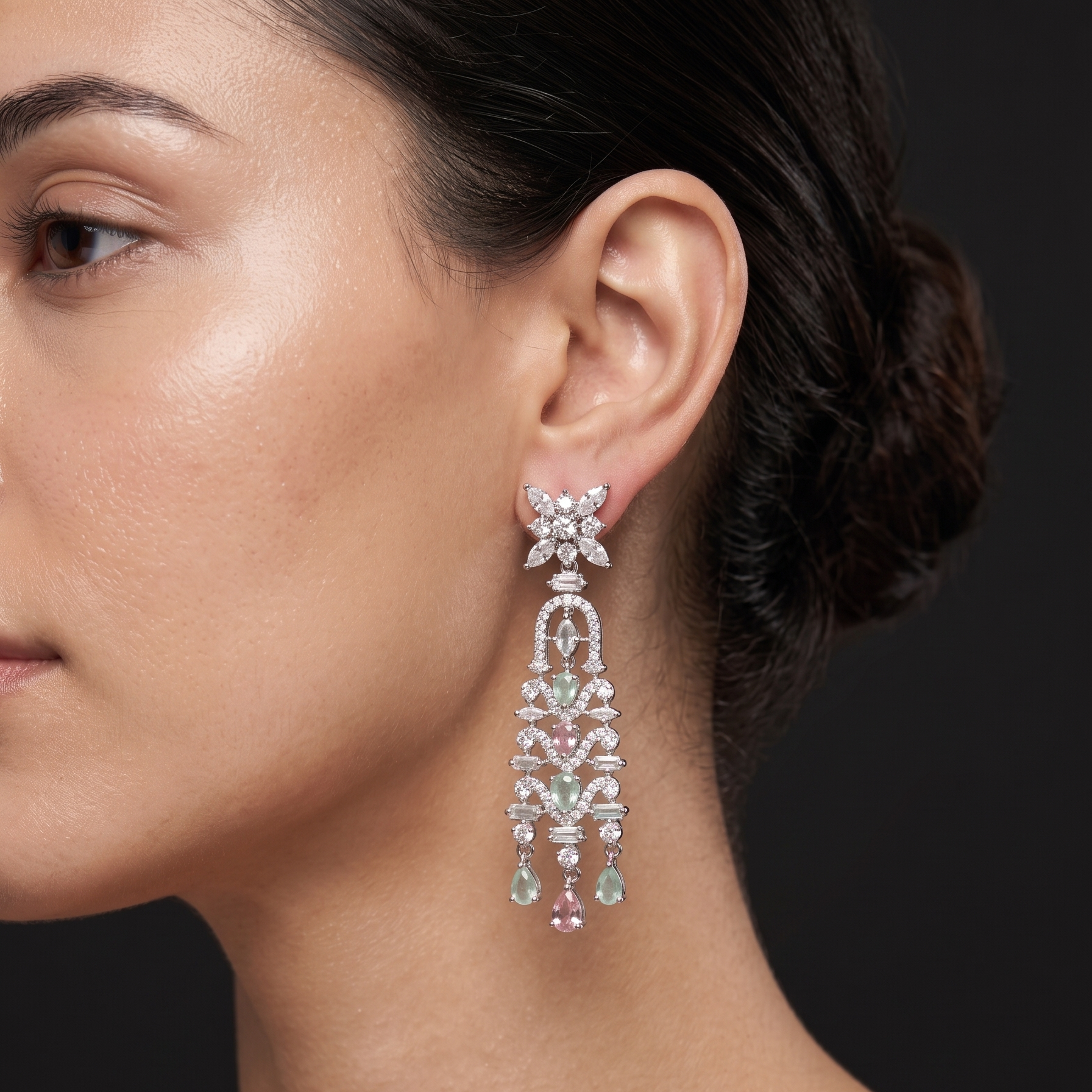 Close-up of a woman wearing a sparkling earring against a dark background