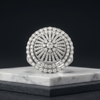 Round diamond ring on a marble stand with a black background