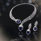Silver necklace and earrings with blue gemstones on a dark background