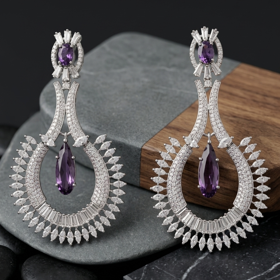 Pair of silver earrings with purple gemstones on a dark surface