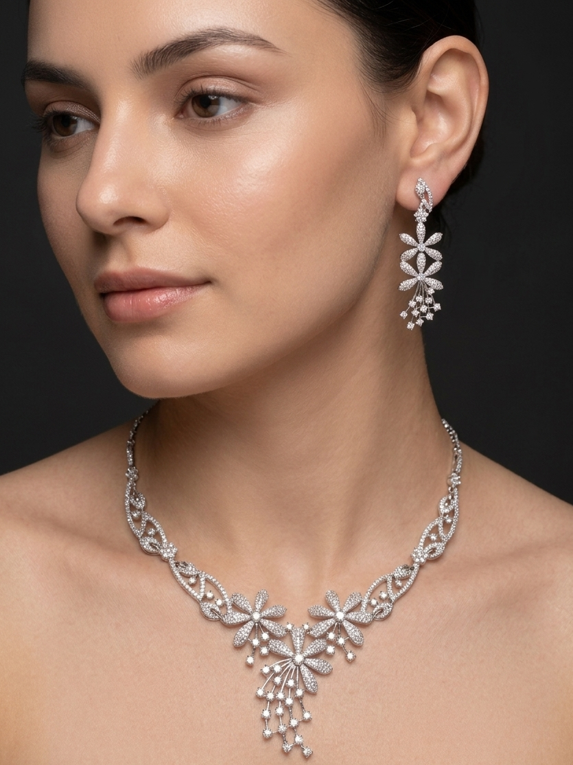 Woman wearing a silver necklace and earrings on a dark background