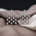 Pair of diamond earrings on a textured fabric surface