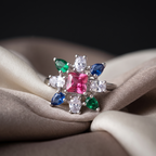 Ring with multicolored gemstones on a beige fabric background