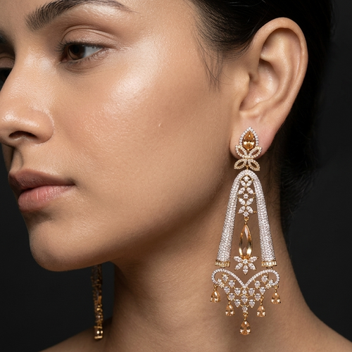 Close-up of a woman wearing elegant gold and diamond earrings against a dark background