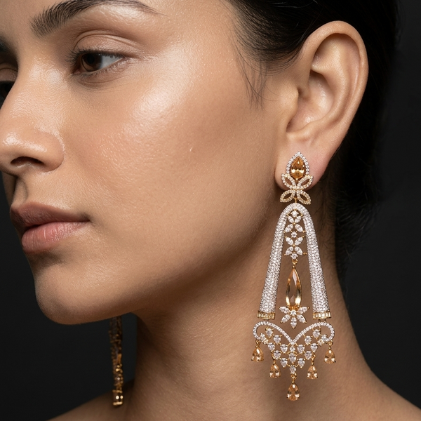 Close-up of a woman wearing elegant gold and diamond earrings against a dark background