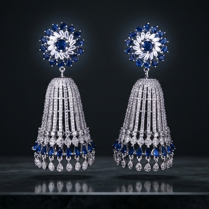 Pair of silver earrings with blue gemstones on a dark background