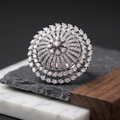 Silver ring with diamond accents on a dark surface
