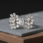 Pair of diamond earrings on a dark surface
