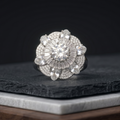 Diamond ring on a dark stone surface with a black background