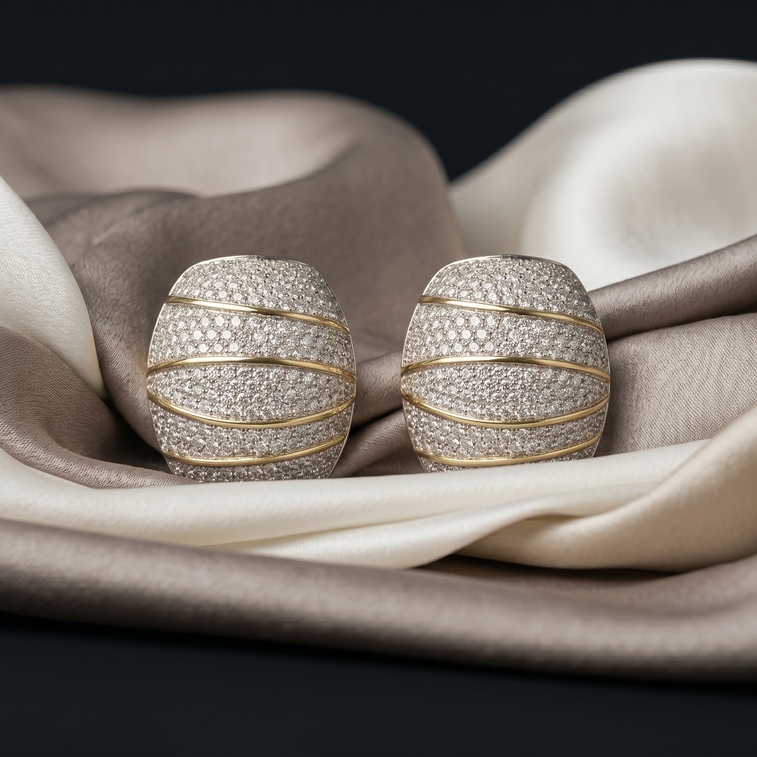 Pair of diamond earrings on a fabric surface