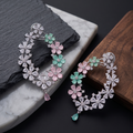 Floral earrings with gemstones on a dark surface