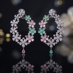 Pair of floral earrings with gemstones on a dark background