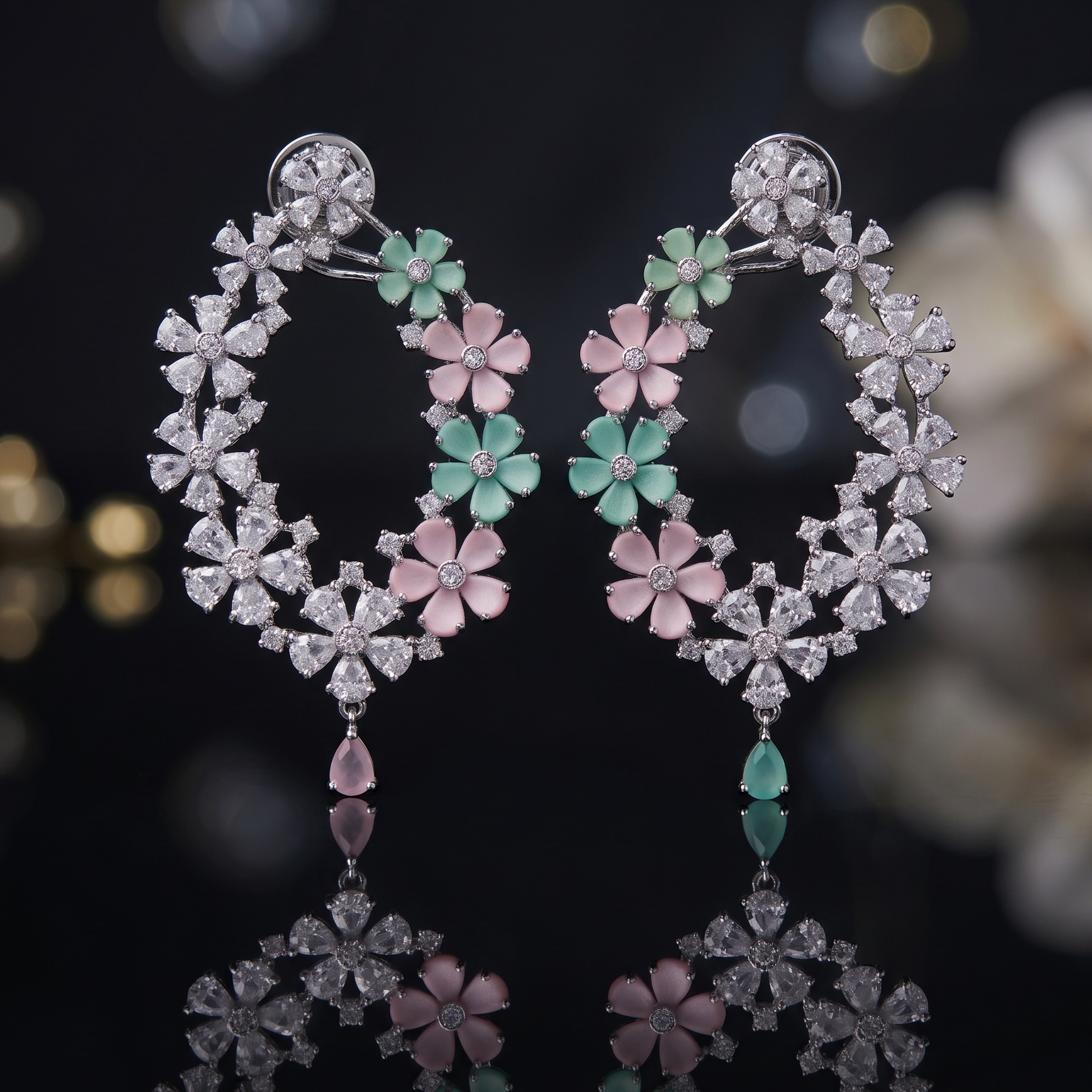 Pair of floral earrings with gemstones on a dark background