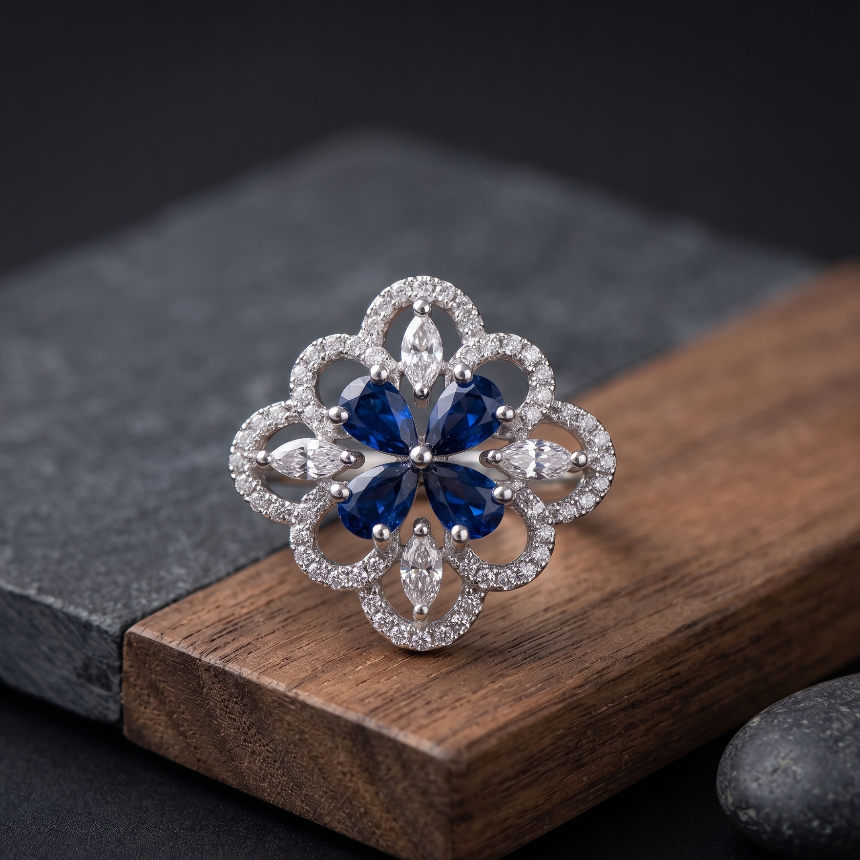 Silver ring with blue gemstone on a wooden block