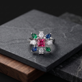 Ring with colorful gemstones on a dark stone surface