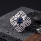 Silver ring with a blue gemstone on a textured stone surface